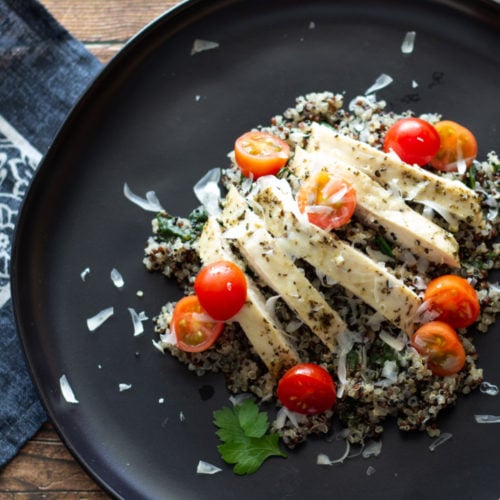 Sliced chicken and cherry tomatoes over quinoa.