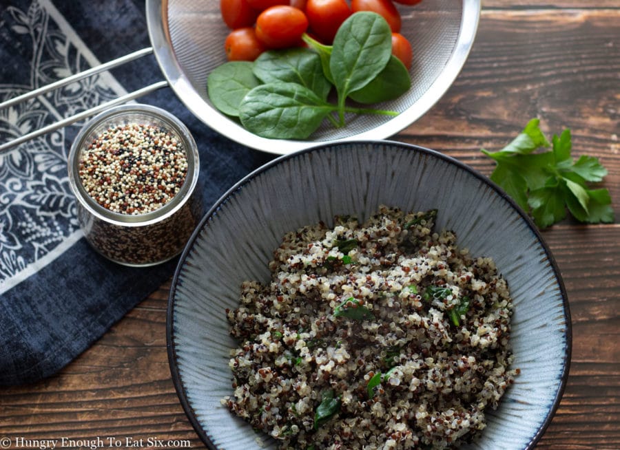 Cooked quinoa with spinach and parsley.