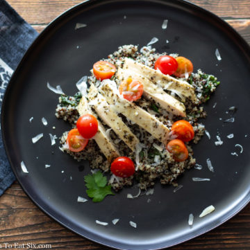 Tricolor quinoa cooked and copped with sliced chicken breast and cherry tomatoes.