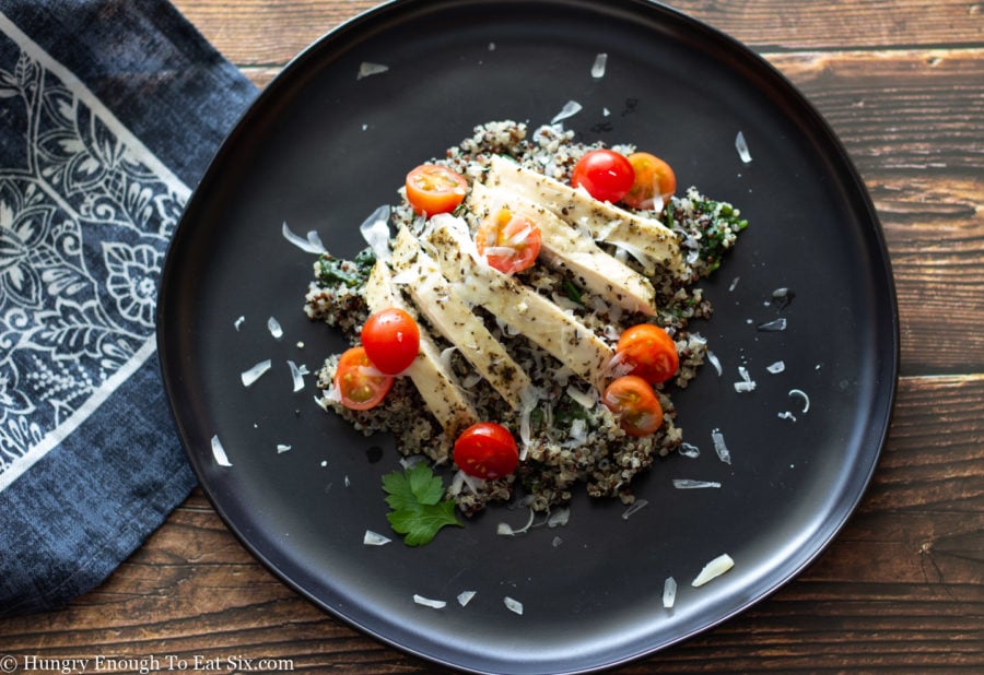 Tricolor quinoa cooked and copped with sliced chicken breast and cherry tomatoes.