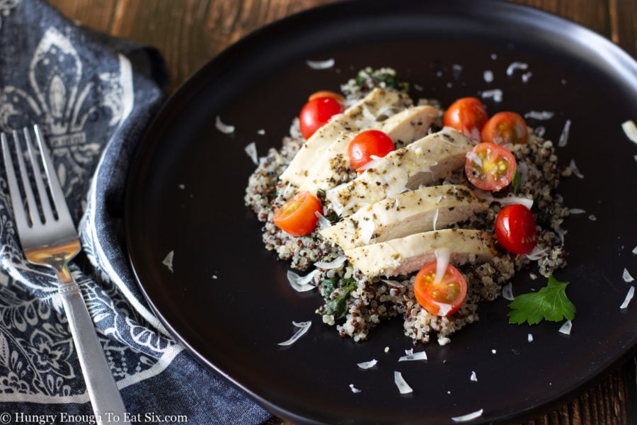 Sliced cherry tomatoes with chicken breast and quinoa.