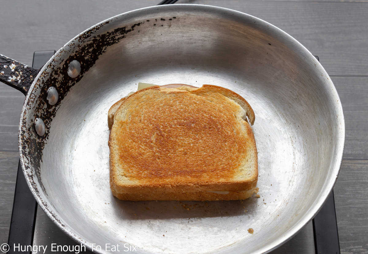 Grilled sandwich in a skillet.