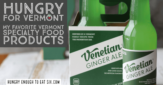Green bottles of Venetian ginger ale on a white surface.