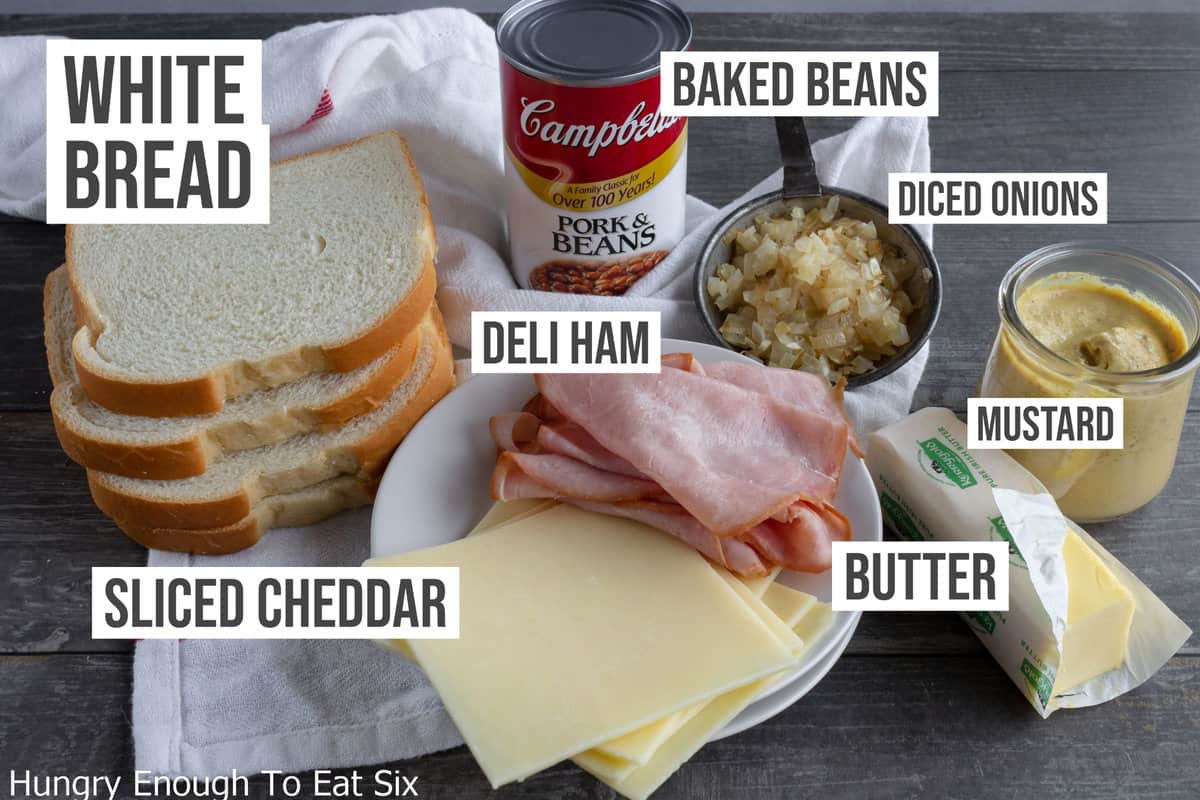 Ingredients: white bread, canned beans, butter, sliced cheese, sliced ham, and diced onions.