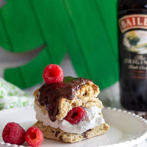 Scone with cream, chocolate, and berries.