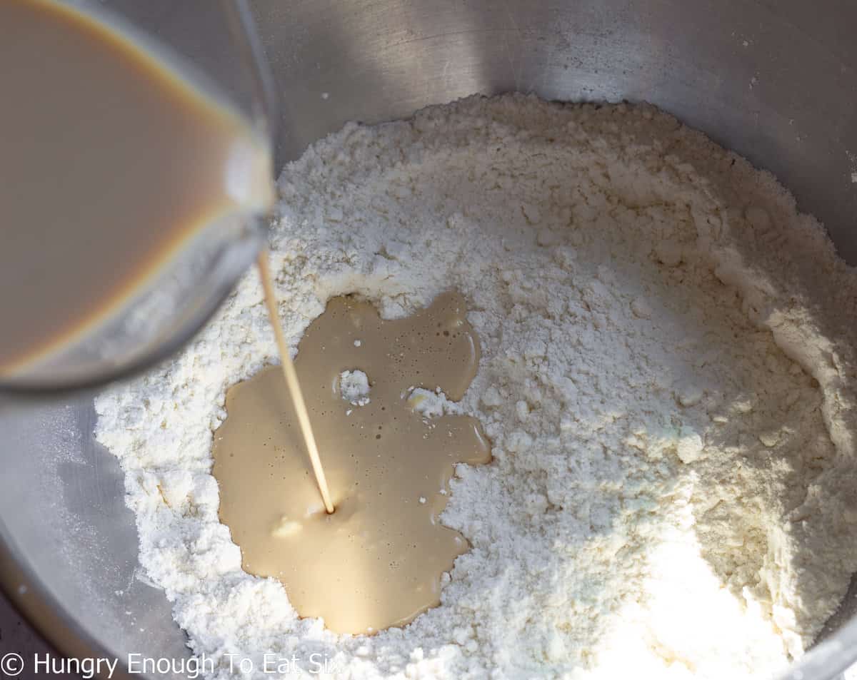Baileys Irish cream pouring into a flour mixture.