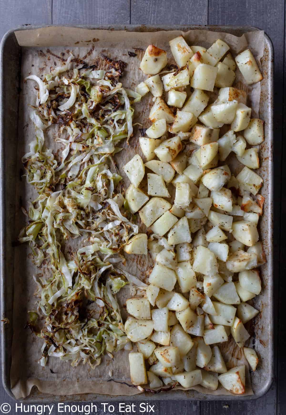 Roasted potatoes and cabbage on sheet pan.