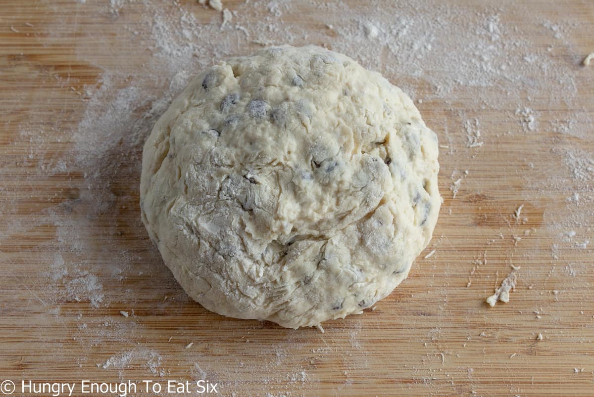 Round bread dough on floured board.