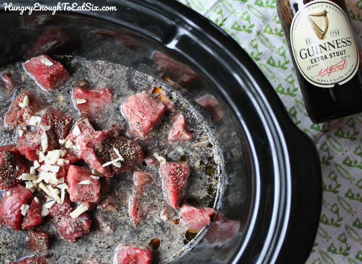Raw beef in a slow cooker pot