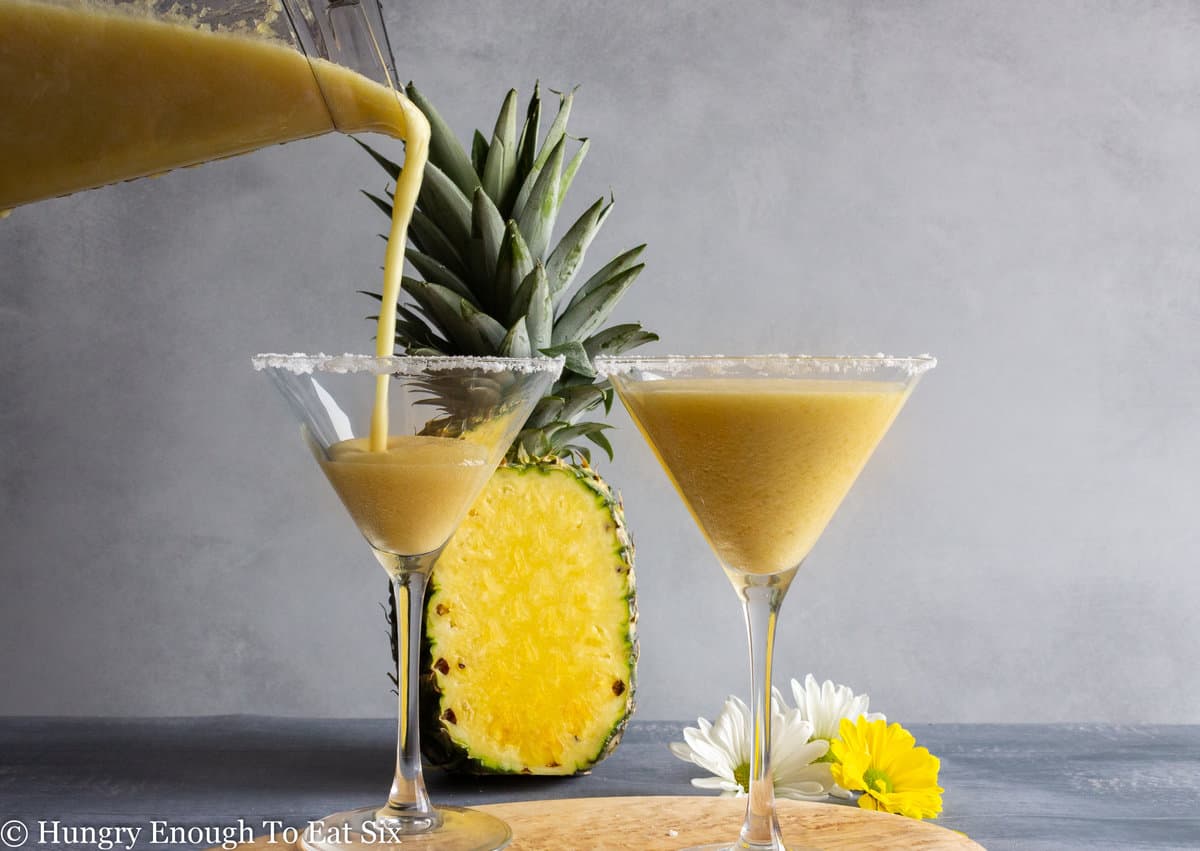 Blended pineapple mixture pouring into glass