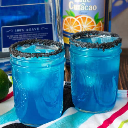 Two mason jars with blue cocktails.