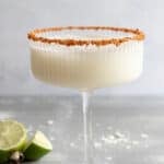 Coconut drink with spice blend on rim of glass.