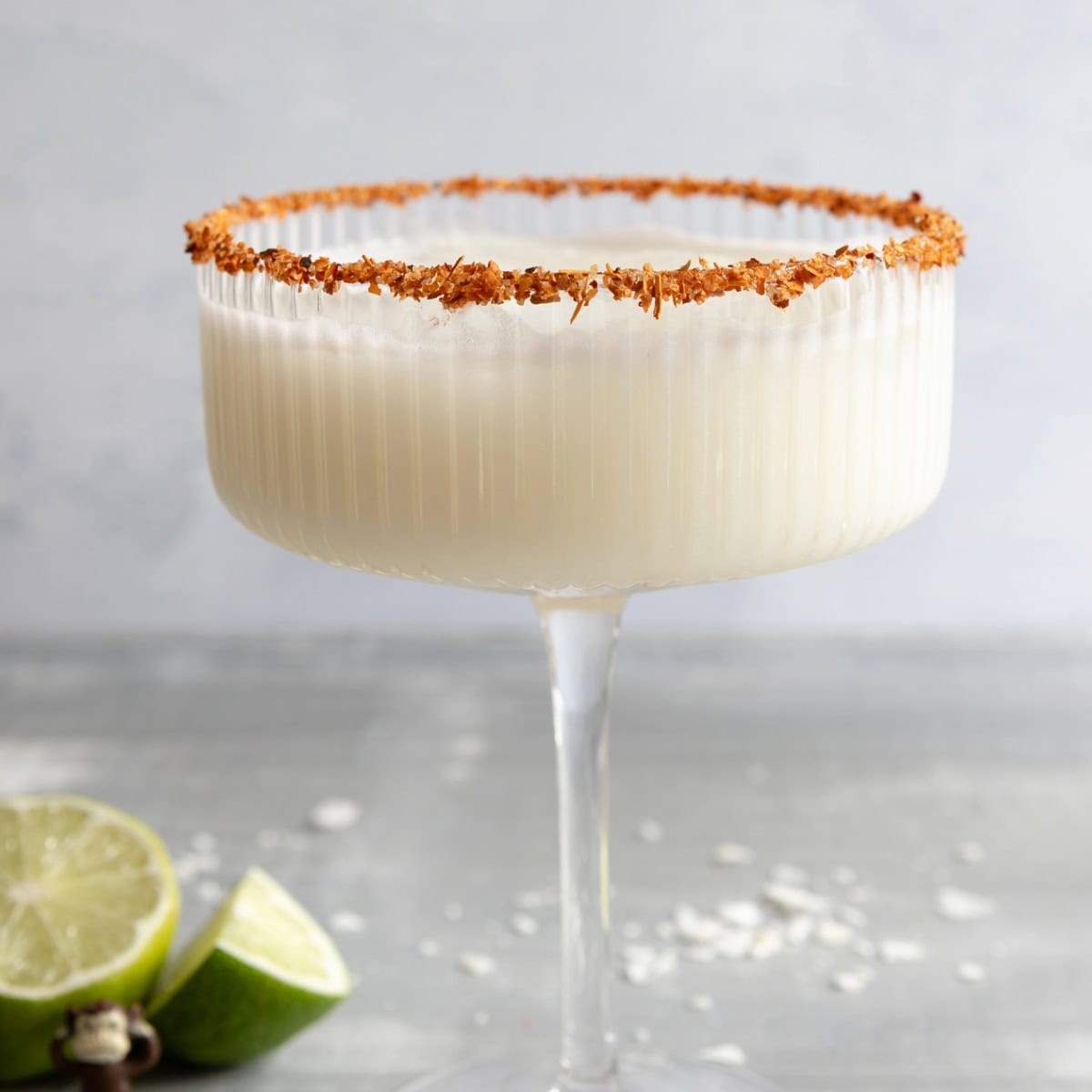 Coconut drink with spice blend on rim of glass.