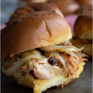 Pulled pork on a slider roll with onions and seasonings.
