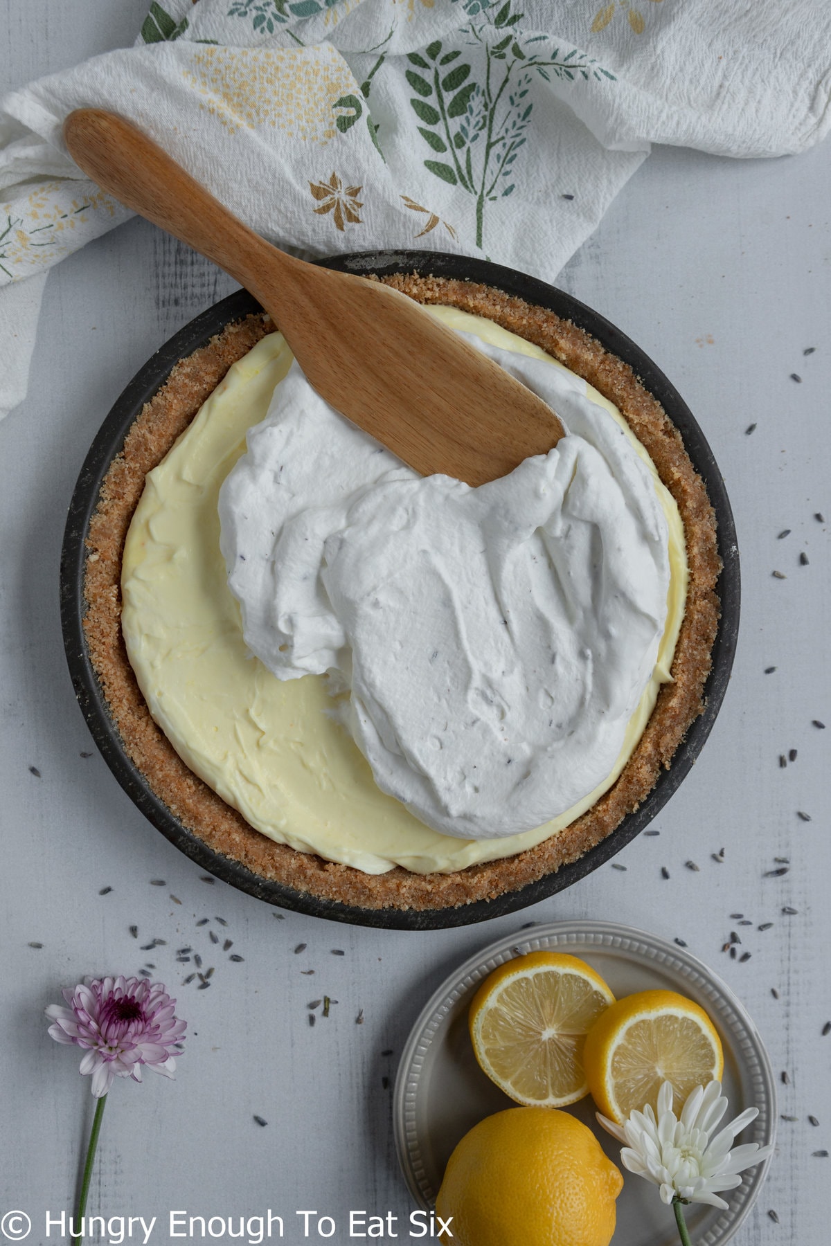 Graham crust pie with lemon pudding and whipped cream on top.