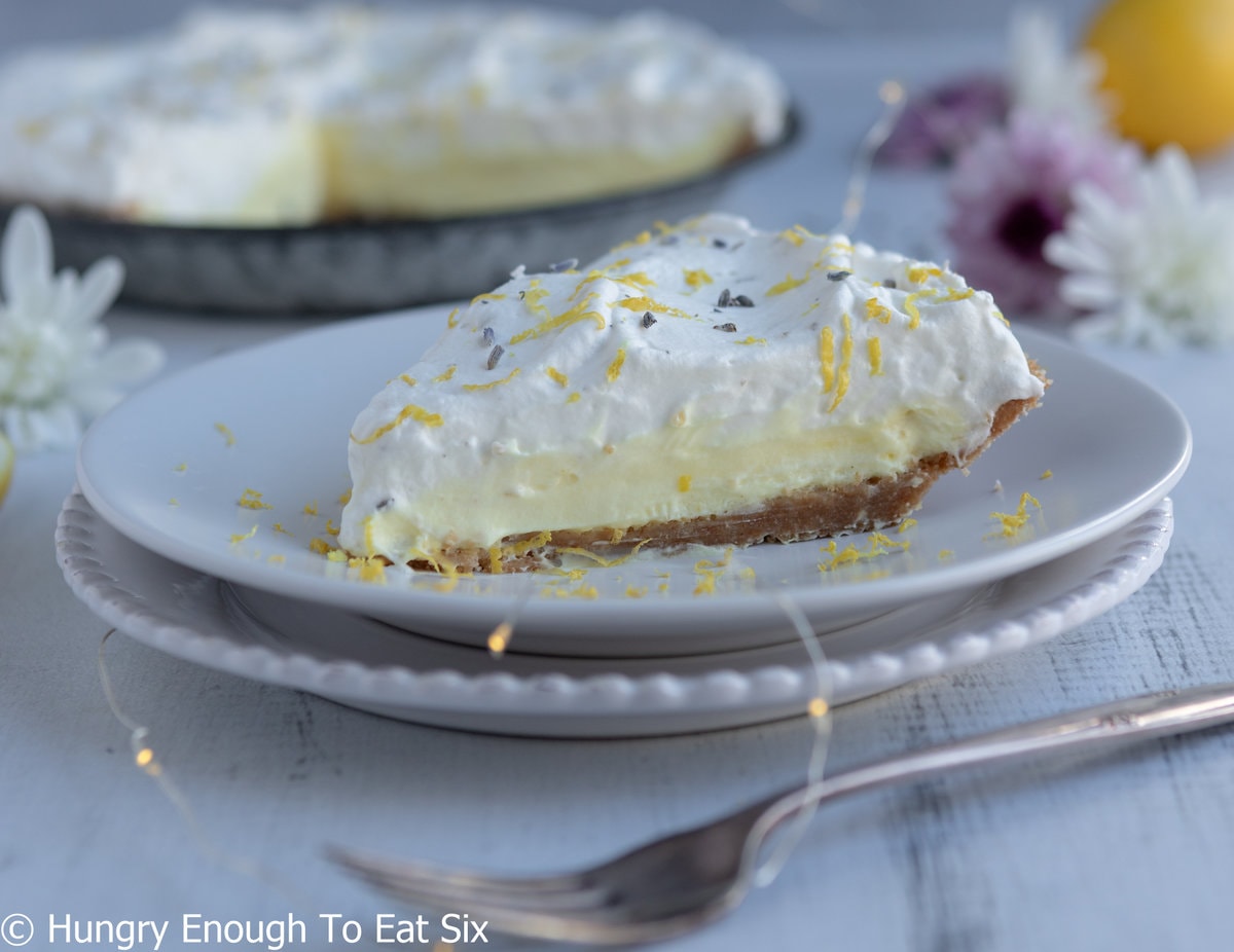 Pie slice with lemon pudding and cream topping.