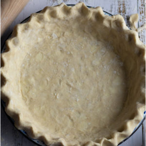 Butter pie pastry crimped in a pie plate.