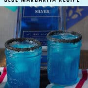 Two blue cocktails with black salt rims.