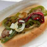 Long roll with sausage and sliced peppers.