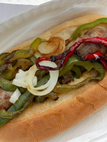 Long roll with sausage and sliced peppers.