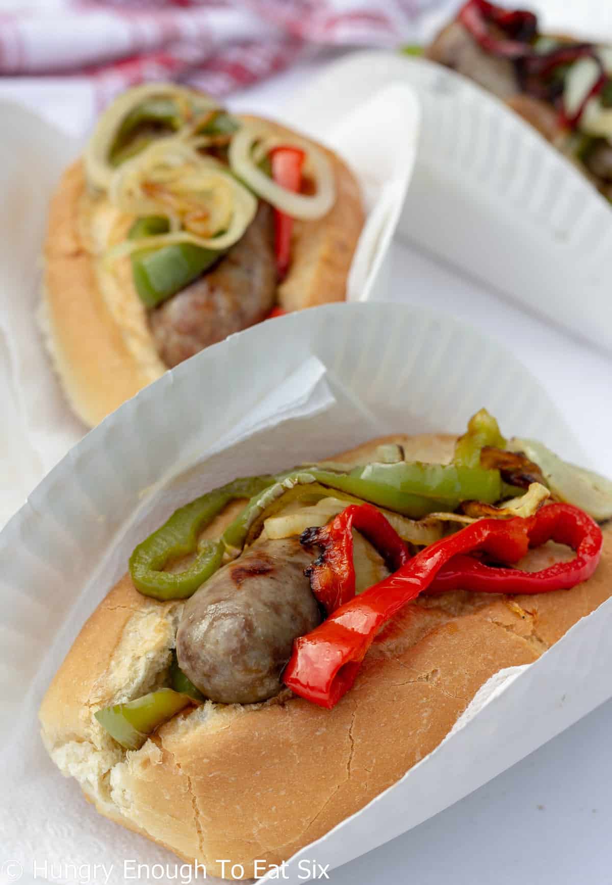 Sausage with peppers and onions on a roll.