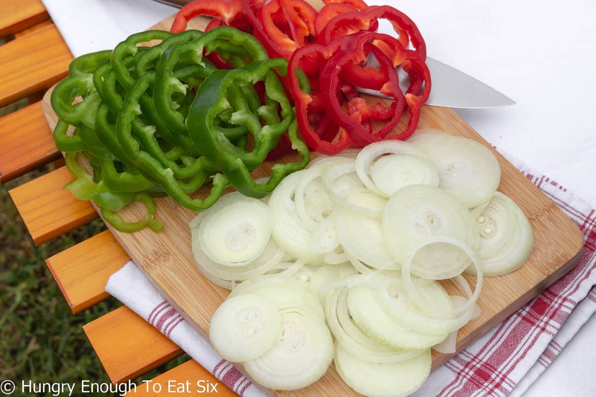 Sliced red and green bell peppers and sliced onions.