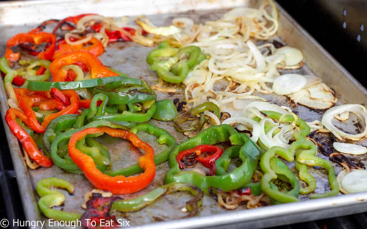 Tray with grilled peppers and sliced onions.