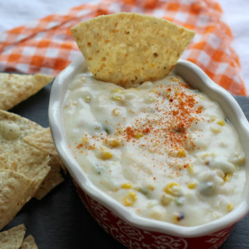 Oval bowl holding thick cheese and corn dip