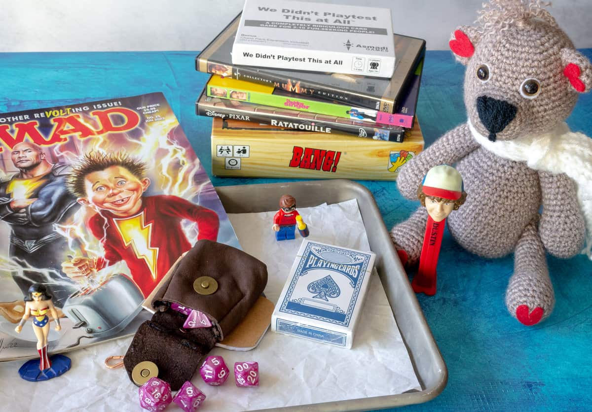 DVDs, small games, Mad Magazine, D&D dice, and a teddy bear.