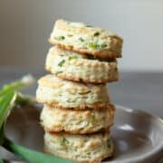 Stack of five biscuits on a gray plate.