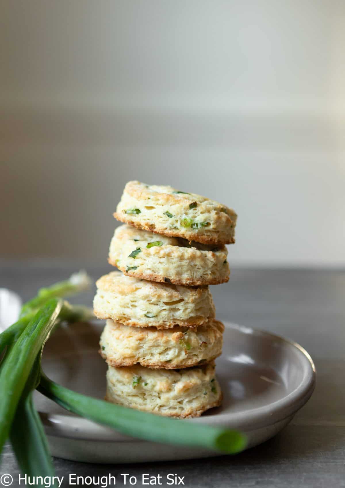 Baked biscuits stacked on a plate.