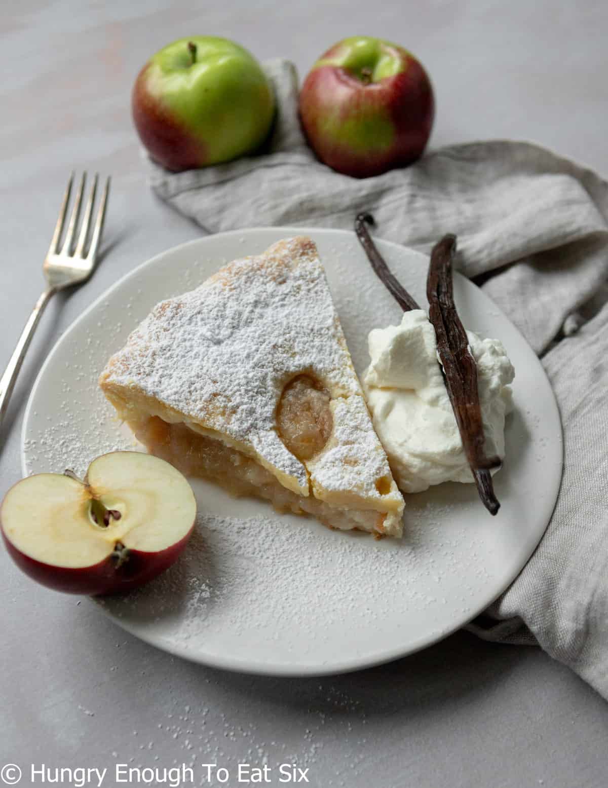 White plate with pie and apple half.