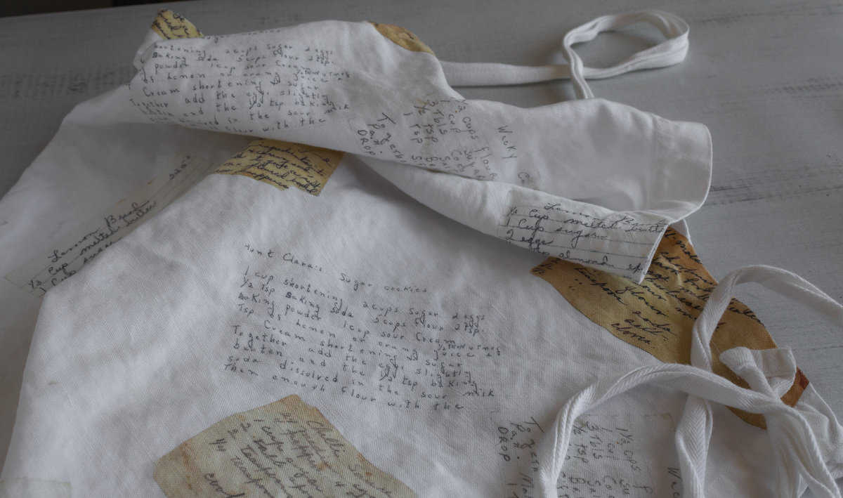 Apron with images of old recipe cards printed on it.