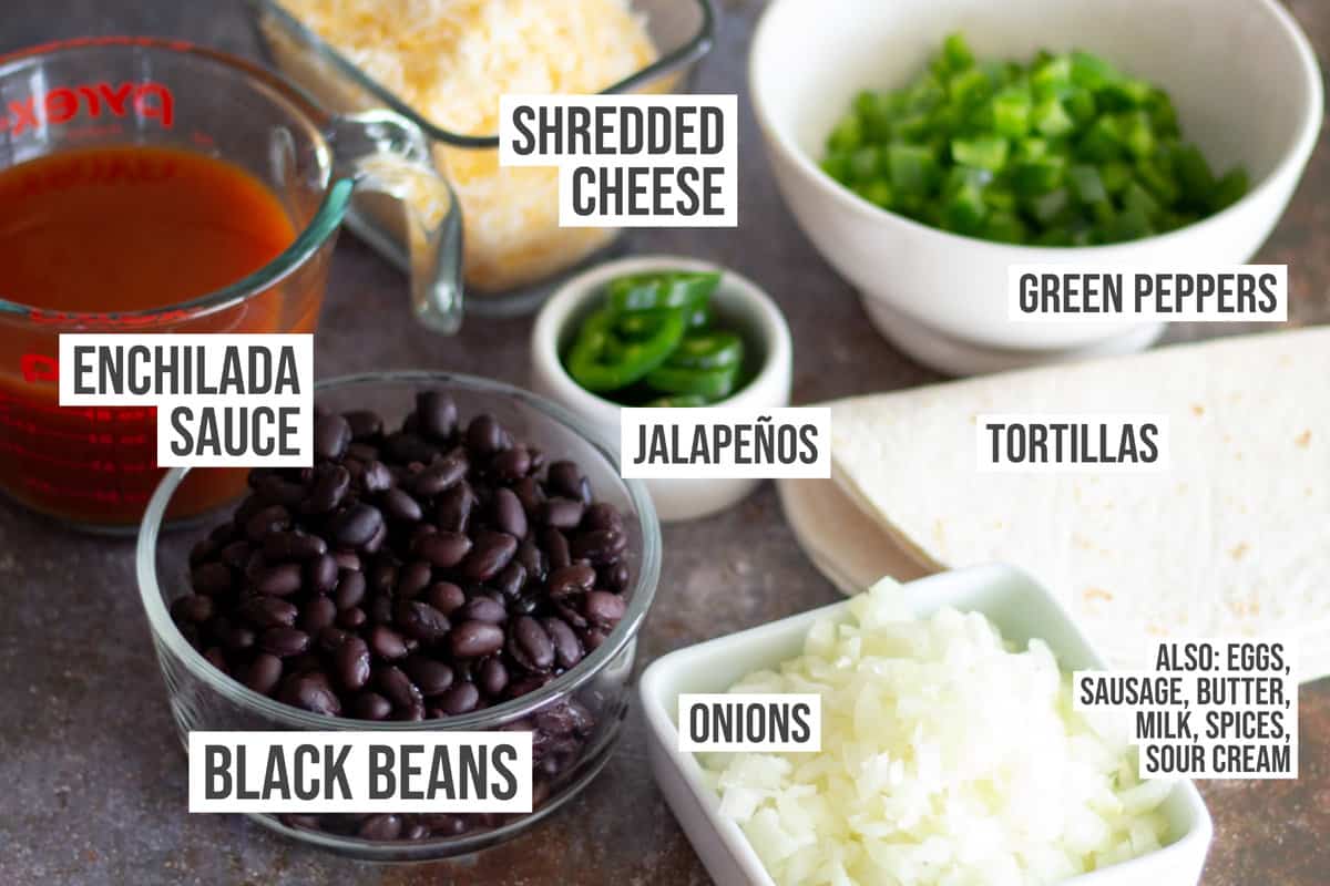 Ingredients like peppers, onions, cheese, black beans, enchilada sauce, tortillas, and jalapenos.