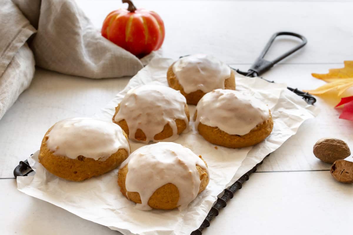 Iced cookies that are orange from pumpkin in the batter.