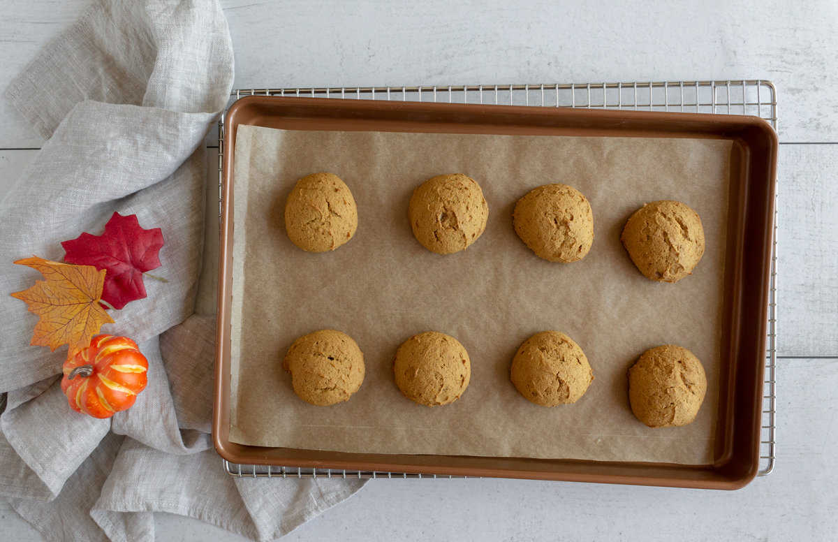 Baked orangey-brown cookies on a baking sheet.