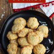 BRowned coconut cookies next to a white and red fringe cloth