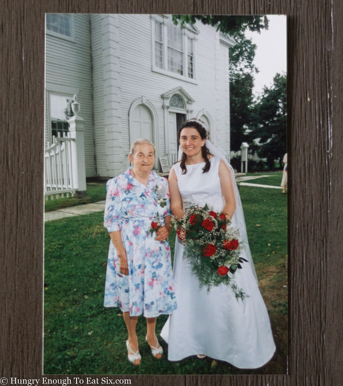Grandmother with granddaughter in a wedding dress