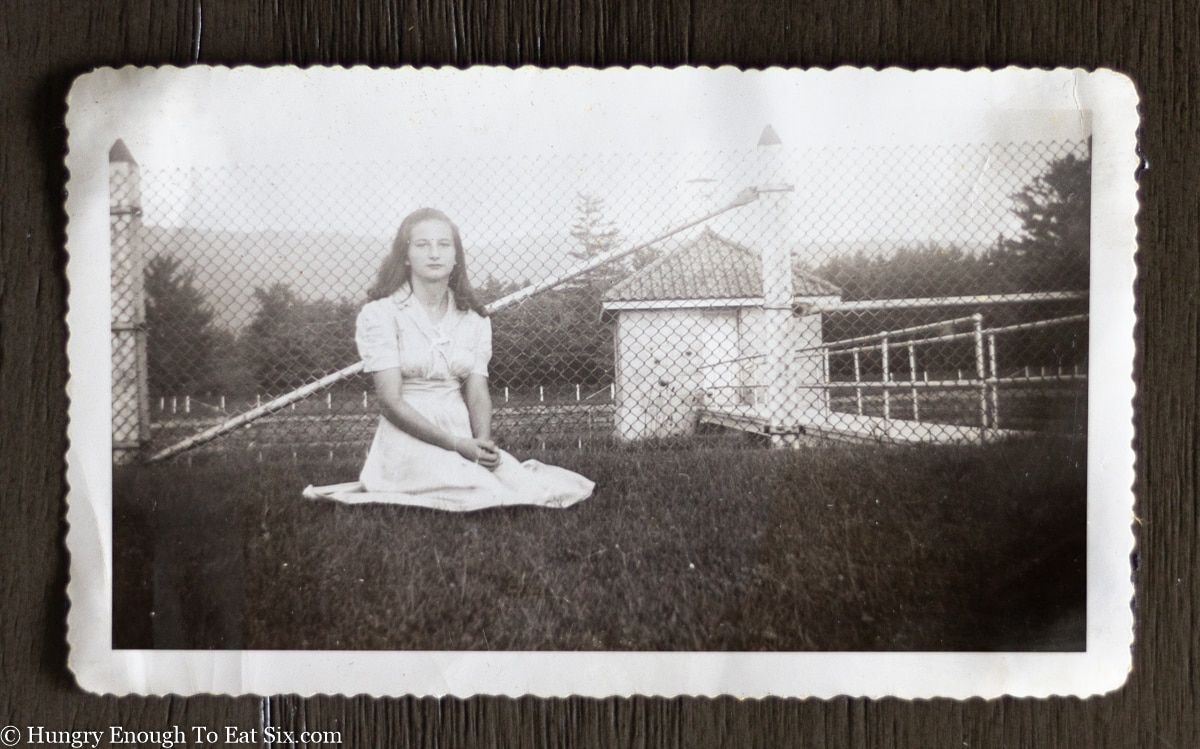 black and white photo of a young woman on a lawn