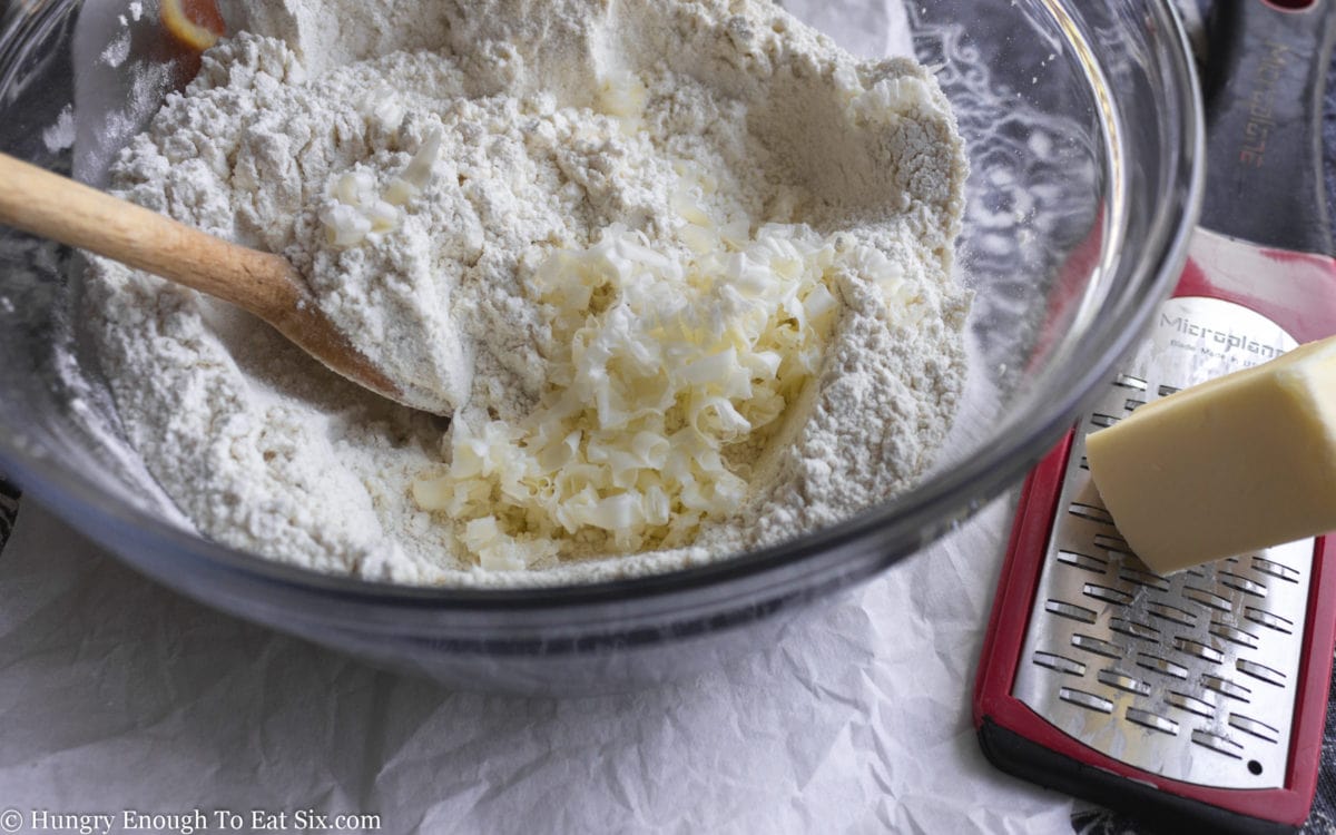 Grated butter in a bowl of flour