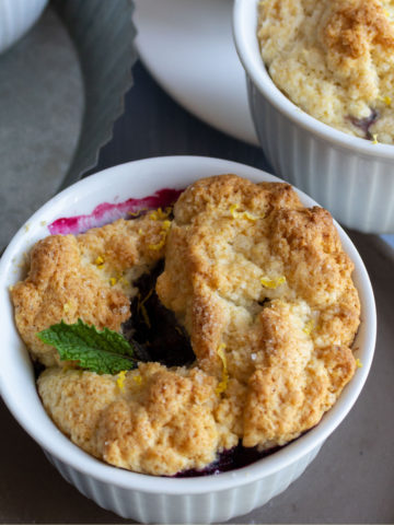 Cobbler with berries and a mint leaf