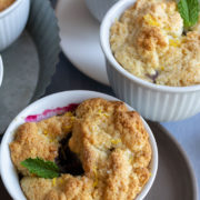 White cups of biscuit topped fruit