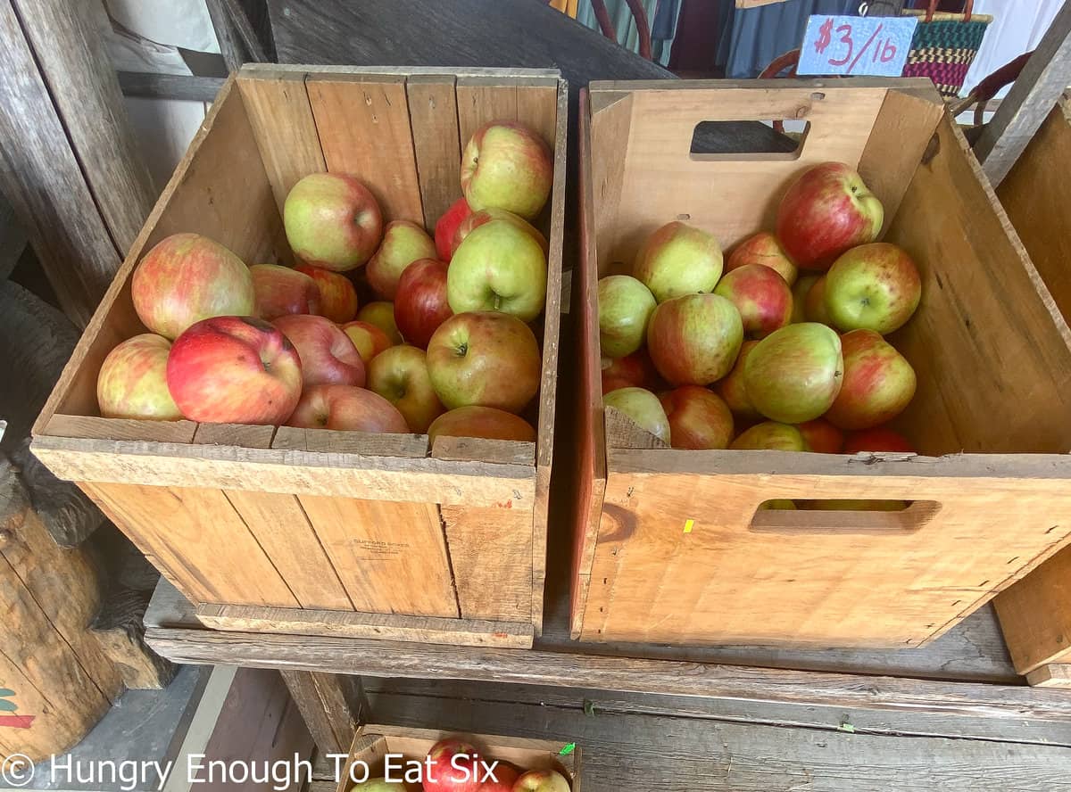 Wooden crates of red and green apples.
