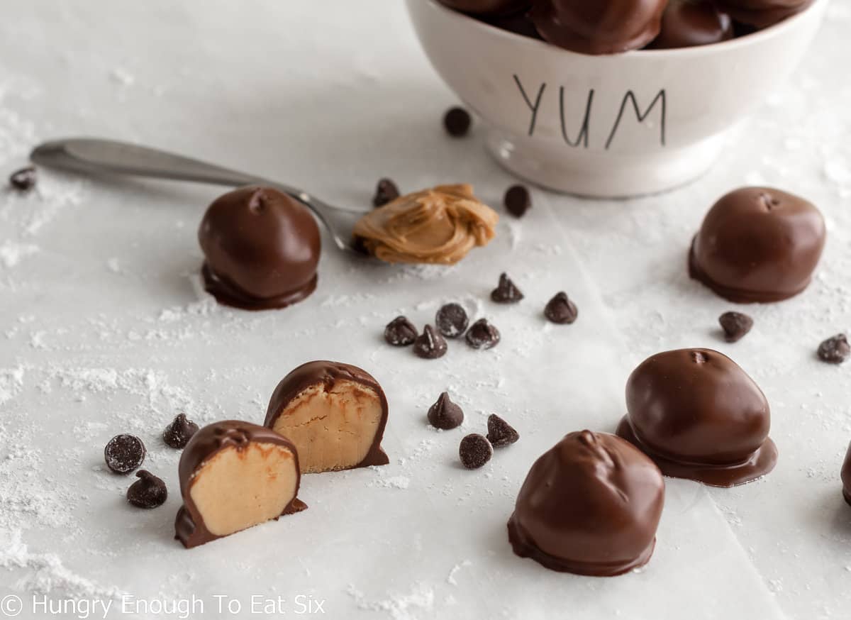 Chocolate covered peanut butter balls, one cut in half. 