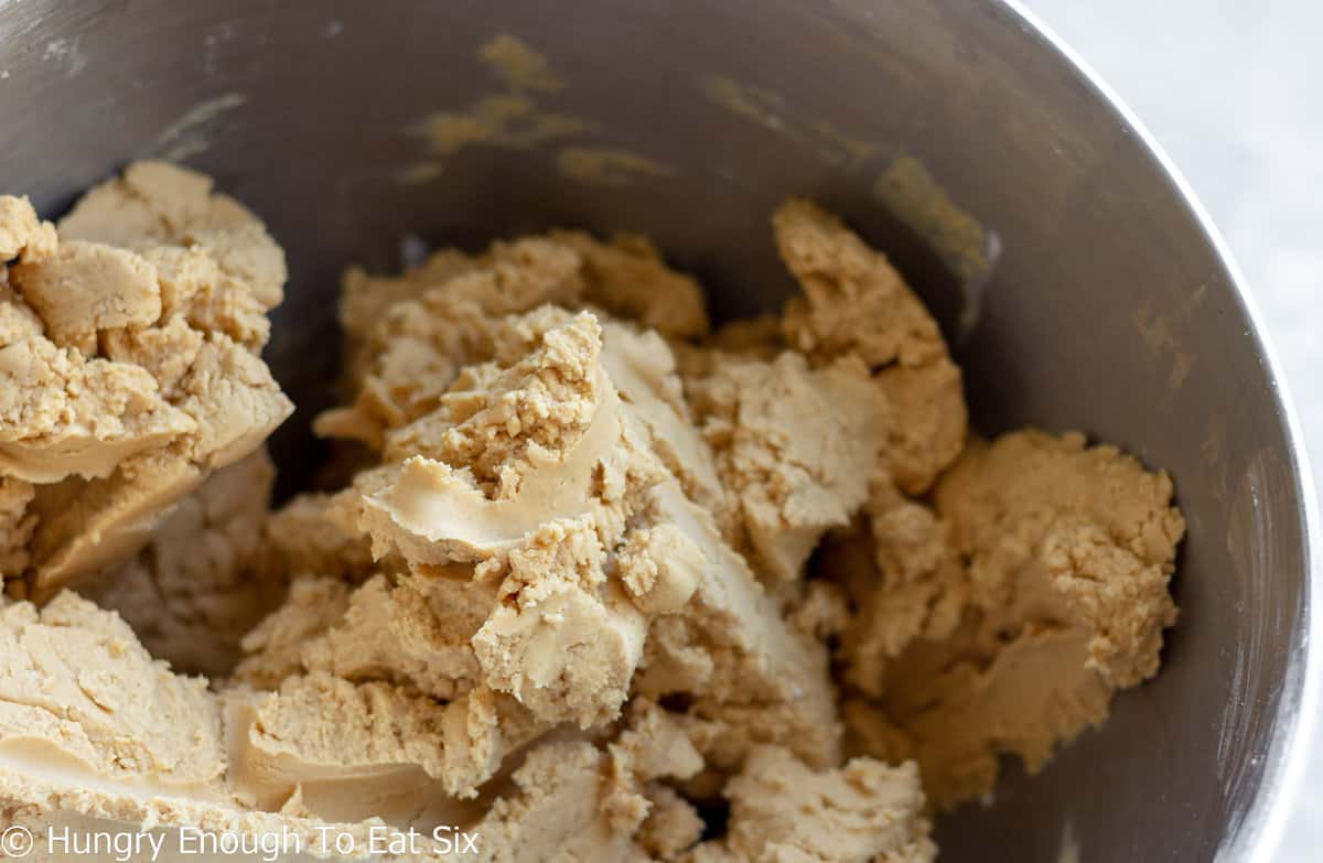 Peanut butter candy dough in a metal mixing bowl.