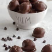 White bowl of chocolate peanut butter balls.