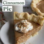 Slice of brown cinnamon pie with whipped cream on a plate.