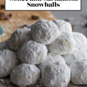 Powdered sugar covered cookies on a plate.