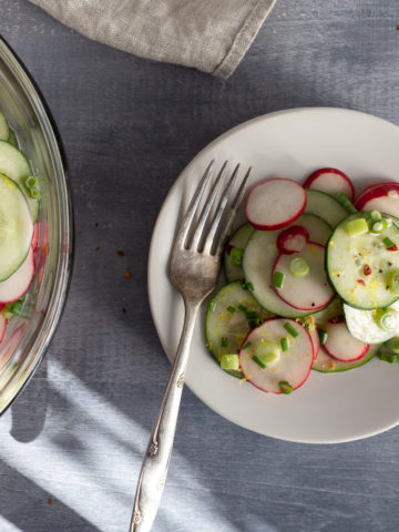 White plate with cucumber salad