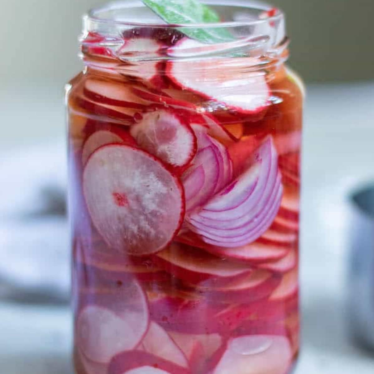 Glass jar of pickled radishes